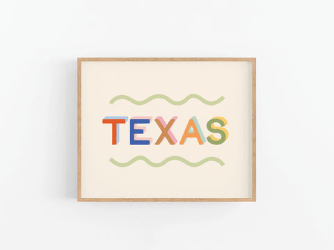 The Funky Texas Art Print by Onderkast Studio features TEXAS in bold colors with wavy green lines, set in a wooden frame on an off-white background—perfect for adding vibrant flair to any space.