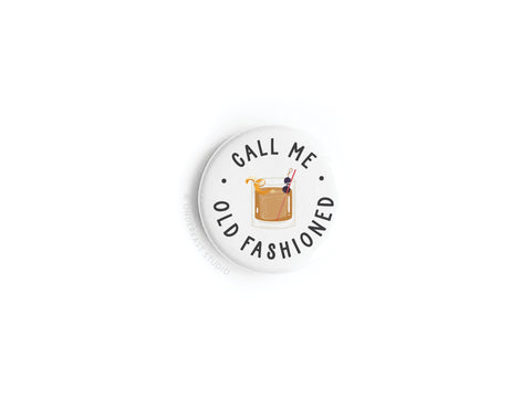 The Call Me Old Fashioned Button Magnet by Onderkast Studio features a vintage-style old fashioned cocktail with orange twist and cherry, plus the phrase Call Me Old Fashioned circling the drink.