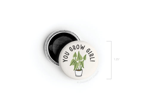 The Onderkast Studio You Grow Girl! Houseplant Button Magnet features a potted plant illustration and the phrase YOU GROW GIRL!—perfect for plant lovers. Shown beside its opened silver backing, it measures 1.25 inches in diameter.