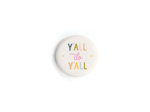 The Y’all Do Y’all Button Magnet by Onderkast Studio features the phrase “Y’all Do Y’all” in colorful blue, yellow, pink, and orange letters on a plain white background.