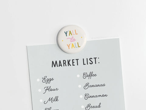 The Y’all Do Y’all Button Magnet by Onderkast Studio adds Southern charm to a light blue MARKET LIST featuring eggs, flour, milk, coffee, bananas, cinnamon, and bread.