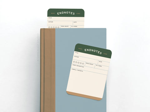 The Endnotes Book Review Card Set by Onderkast Studio features two vibrant, premium card stock cards—perfect as bookmarks or companions to any blue hardcover. Each card offers spaces for book details, star ratings, descriptions, and personal notes.