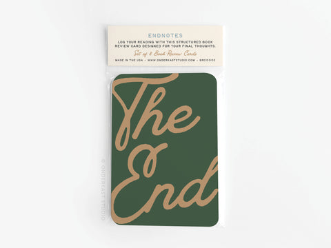 The Endnotes Book Review Card Set by Onderkast Studio features dark green cards with The End in gold script, packaged in a clear sleeve. Log your reading on premium, vibrant card stock designed for capturing final thoughts.
