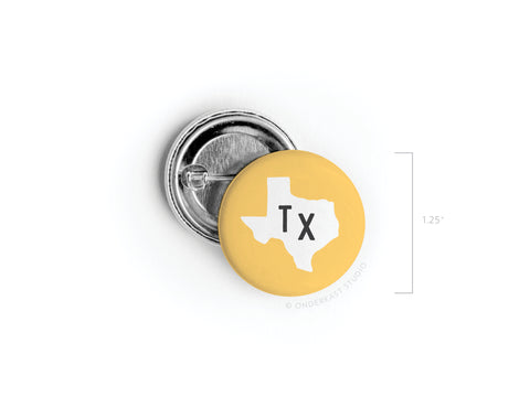 Show your Texas pride with the Yellow TX Pinback Button by Onderkast Studio. This 1.25-inch round pin features vibrant yellow, a white Texas silhouette, and bold black Tx letters; front and back views are displayed.