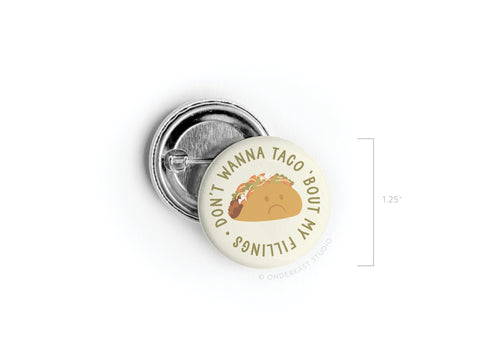 The Onderkast Studio “Don’t Wanna Taco ‘Bout It” Pinback Button is a 1.25-inch round pin featuring a sad taco and funny text—perfect for taco lovers. The product photo shows the design front and its back side.