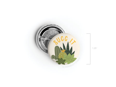 The Succ It Succulents Pinback Button by Onderkast Studio features “SUCC IT” in yellow above a succulent design. At 1.25 diameter, it’s perfect for plant lovers and collectors.