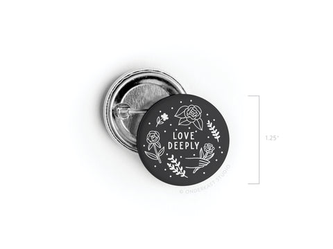 The Love Deeply Pinback Button – DISCONTINUED by onderkast studio is a 1.25 round accessory featuring white floral designs and “LOVE DEEPLY” in the center, with high-quality, vibrant printing on a white background.