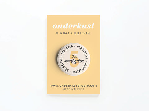The Enneagram Pinback Button – 5 The Investigator by Onderkast Studio is shown on a yellow card with onderkast PINBACK BUTTON, www.onderkaststudio.com, and MADE IN THE USA printed at the bottom.