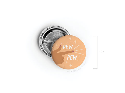 Add some flair with the Pew Pew Pinback Button by Onderkast Studio! This high-quality 1.25 button features a playful finger-gun hand design, sparkles, and PEW PEW text on a peach background—perfect for showing off your fun side.