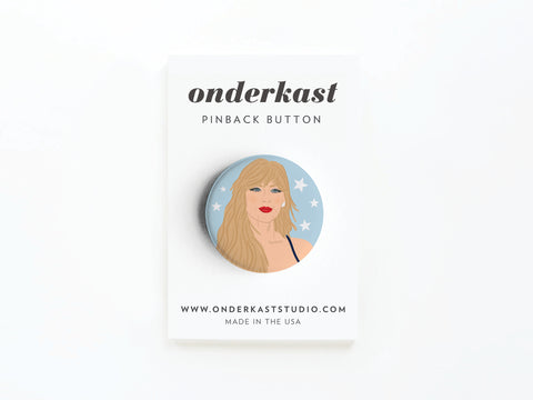 The TS Midnights Pinback Button by Onderkast Studio features an illustrated blonde woman on a blue, starry background, attached to a white card labeled onderkast pinback button with website info at the bottom.