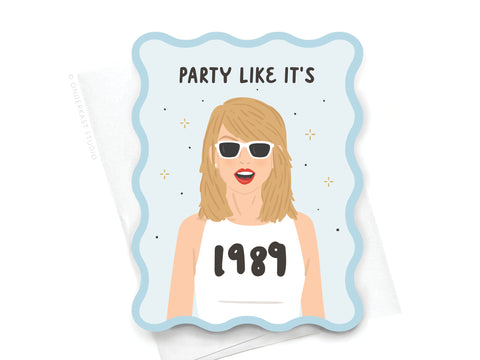 The TS 1989 Wavy Die Cut Notecard by Onderkast Studio features a blonde woman in white sunglasses and a “1989” shirt, surrounded by sparkles and “Party like its” text—a must-have Swiftie charm for your stationery collection!.