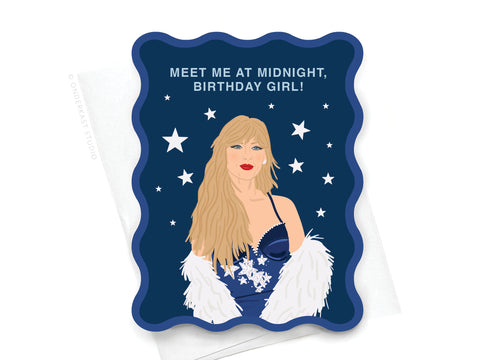 The Onderkast Studio TS Midnights Wavy Die Cut Notecard features an illustration inspired by Taylor Swift—a blonde woman in a blue dress with white feathered shawl—under a starry sky, reading MEET ME AT MIDNIGHT, BIRTHDAY GIRL! at the top.