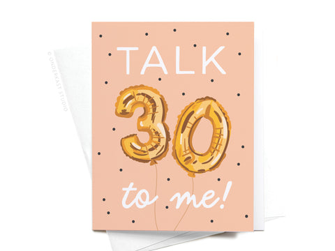 The Onderkast Studio Talk 30 to Me Balloons Greeting Card features gold “30” balloons, black polka dots on peach, and a fun message. A white envelope is included with this playful 30th birthday card.