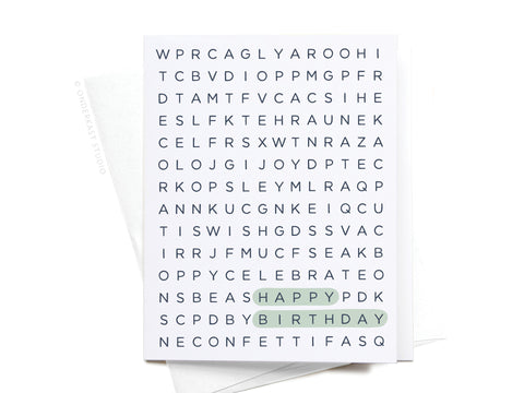 The Happy Birthday Word Search Greeting Card by Onderkast Studio features HAPPY and BIRTHDAY highlighted in green on a white card, making it a unique birthday greeting. The card is shown atop a white envelope.