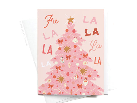 The Fa La La Pink Christmas Tree Greeting Card by Onderkast Studio features a pink tree with ornaments, bows, and a star, set against a colorful “Fa la la la la” background. Comes with a white envelope.