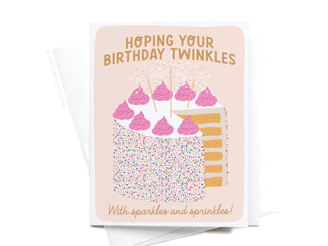 The Birthday Sparkles and Sprinkles Greeting Card by Onderkast Studio features a cake with pink frosting, sprinkles, and sparklers, plus the message Hoping your birthday twinkles with sparkles and sprinkles!—sweet for any celebration.