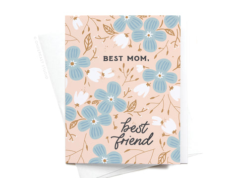 The Onderkast Studio Best Mom Best Friend Greeting Card features blue and white flowers on a peach background with “BEST MOM, best friend” in black text. Ideal for Mother’s Day, it comes with a white envelope.