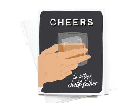 The Cheers to a Top Shelf Father Greeting Card by Onderkast Studio features an illustrated hand holding a glass of whiskey, with “CHEERS” at the top and “to a top shelf father” in white on a dark background.