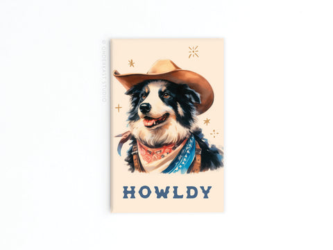 The Howldy Cowboy Dog Refrigerator Magnet by Onderkast Studio features a playful black and white cowboy dog above bold HOWLDY text, adding western charm and fun to your fridge.