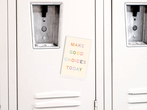 A light gray locker with vents and a combination lock features the Onderkast Studio Make Good Choices Today Refrigerator Magnet in pastel colors, serving as daily inspiration for wise decisions.