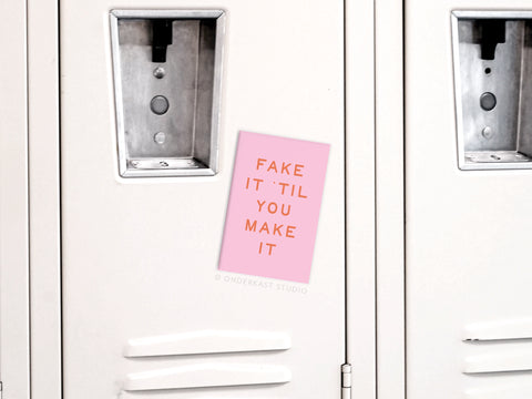 The Fake It ’Til You Make It Refrigerator Magnet by Onderkast Studio adds a confident touch to your fridge or locker with its bold pink design—proudly Made in USA.