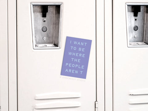 The Onderkast Studio Be Where the People Aren’t Refrigerator Magnet in pastel purple adds quiet humor and introvert vibes to any white locker, featuring the phrase: I want to be where the people arent.