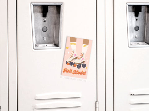 The Roll Model Rollerskates Refrigerator Magnet by Onderkast Studio features a vintage pastel design with hearts and stars, adding playful nostalgia to any locker or fridge.