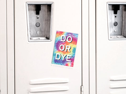 A vibrant Do Or Dye Tie Dye Refrigerator Magnet by Onderkast Studio, featuring bold psychedelic colors, adds a lively splash to the plain white metal locker.