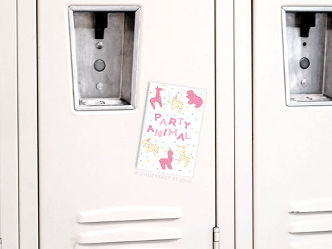 A white locker with an Onderkast Studio Party Animal Frosted Animal Cookies Refrigerator Magnet, featuring pink and yellow animal illustrations and bold PARTY ANIMAL text.