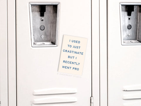 Show off your procrastination skills with the Crastinater Pro Refrigerator Magnet from Onderkast Studio—a vibrant magnet that reads, I used to just crastinate but I recently went pro, perfect for any white locker or fridge.