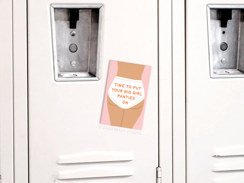 The Big Girl Panties Refrigerator Magnet by Onderkast Studio features a persons lower torso in underwear with “Time to put your big girl panties on” in orange, making it a fun, empowering daily motivation piece for your fridge or locker.