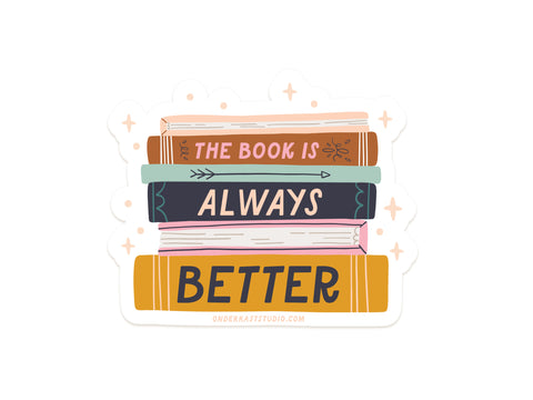 The Book Is Always Better Sticker by Onderkast Studio features five stacked books with the phrase on their spines, surrounded by stars and sparkles. This vibrant vinyl sticker is made in the USA—perfect for book lovers!.