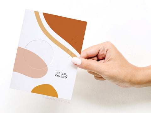 a person holding a card with a design on it
