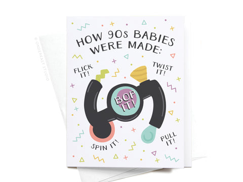 The How 90s Babies Were Made Greeting Card by Onderkast Studio features a Bop It toy with confetti shapes and playful commands—Flick it! Spin it! Twist it! Pull it! Bop it!—making it perfect for fans of 90s nostalgia.
