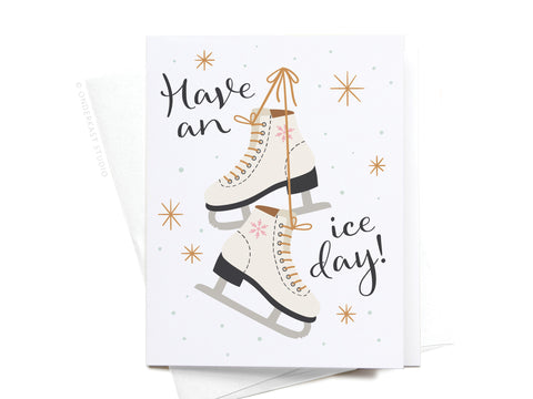Onderkast Studio’s “Have an Ice Day! Ice Skates Greeting Card – FINAL STOCK” features illustrated ice skates tied by their laces with snowflakes and stars, the message “Have an ice day!”, and comes with a crisp white envelope.