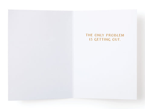 An open Get Into the Holiday Spirits! Cocktail Greeting Card by Onderkast Studio with plain white pages. Gold text on the right reads: THE ONLY PROBLEM IS GETTING OUT. The left page is blank, creating a simple, premium holiday card.