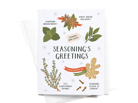 The Seasoning’s Greetings Greeting Card by Onderkast Studio features festive illustrations of bay leaf, star anise, ginger, and thyme with playful puns like “Seasoning’s Greetings” and “Sending Clove & Cheer!” for a cheerful holiday touch.