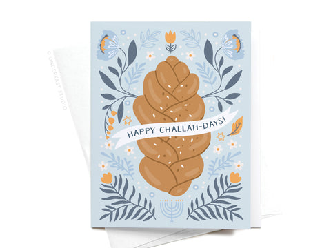 The Happy Challah-days! Greeting Card by Onderkast Studio features braided challah bread, blue and orange florals, a menorah, and Stars of David—a festive illustrated card for celebrating Hanukkah.