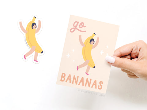 A hand holds Onderkast Studio’s Go Bananas Sticker Greeting Card, printed on thick white card stock with a banana-costumed character and “go BANANAS,” plus a matching vinyl sticker of the same design on a white background.
