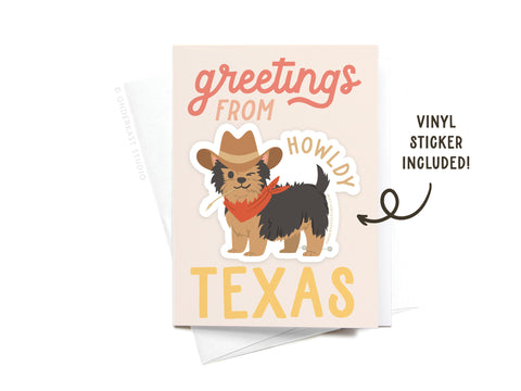 The Onderkast Studio Greetings From Texas Sticker Greeting Card features a white card with “greetings from Texas” and a small dog in a cowboy hat and bandana, plus a matching vinyl sticker. “Vinyl sticker included!” shown next to the dog.