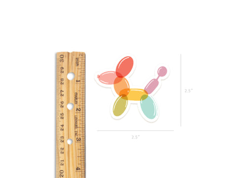 The Balloon Animal Sticker by Onderkast Studio is a vibrant, water-resistant vinyl sticker measuring 2.5 x 2.5 inches, shown next to a wooden ruler for scale.
