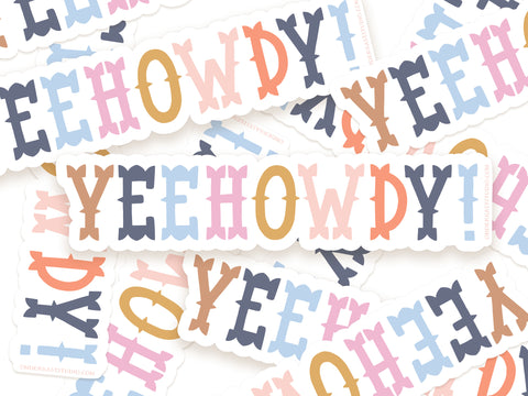 The Yeehowdy! Sticker by Onderkast Studio features bold, playful letters in pastel colors, arranged in a scattered pile. Made from durable, water-resistant vinyl, each sticker stands out with its vibrant design.
