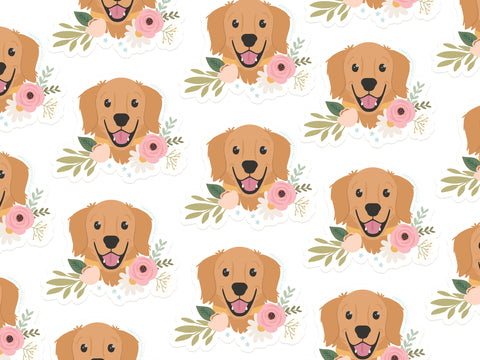 The Onderkast Studio Golden Retriever Floral Sticker features smiling golden retriever faces with pink flowers and green leaves on white, made from durable, water-resistant vinyl.