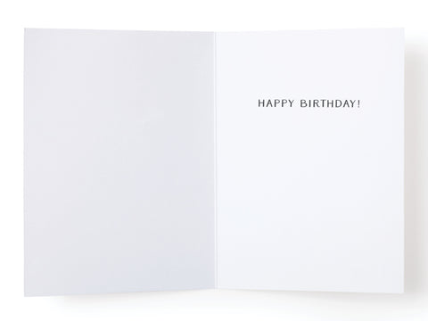 An open How 90s Babies Were Made Greeting Card by Onderkast Studio with a plain white interior and HAPPY BIRTHDAY! printed in bold, black uppercase letters on the right side.