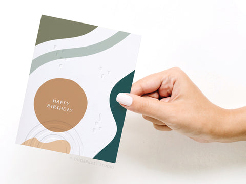 a hand holding a card that says happy birthday