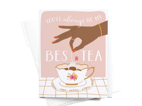 The You’ll Always Be My Bestea Greeting Card by Onderkast Studio features a playful hand dipping a tea bag into a floral cup with the message “You’ll always be my BEST TEA”—a perfect dark-toned card for your tea-loving friend.