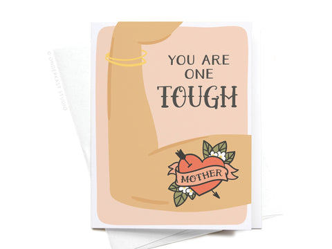 The You Are One Tough Mother Greeting Card by Onderkast Studio features a flexed arm, gold bracelet, and heart tattoo with flowers. Vibrantly printed, its a premium tribute to Moms strength. Text on card: You are one tough.