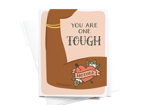 Featuring a flexed brown arm with a gold bracelet, floral Mother heart tattoo, and You are one tough in vibrant colors, the Onderkast Studio You Are One Tough Mother Greeting Card offers a premium look on light beige.