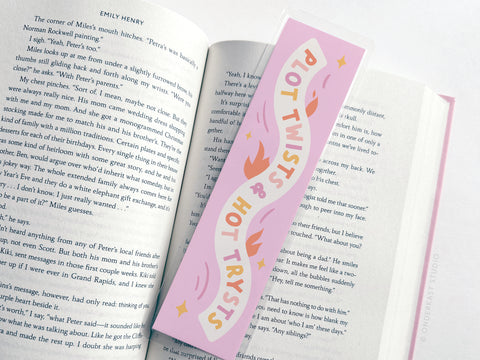 The Easyhand Goods Plot Twists & Hot Trysts Laminated Bookmark, featuring pale pink and orange abstract designs, is printed in the USA for durability—perfect for stylishly saving your place in any book.
