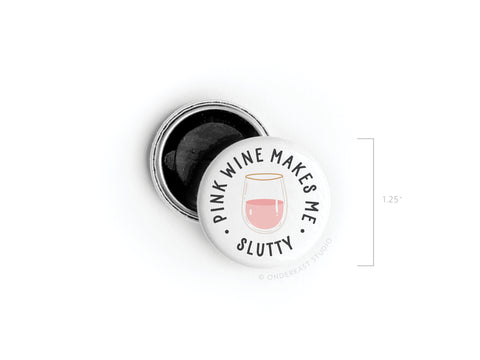 The Onderkast Studio Pink Wine Makes Me Slutty Button Magnet is a 1.25-inch round white metal tin with a lid featuring that phrase around a pink wine glass illustration—perfect for pink wine lovers with a sense of humor.